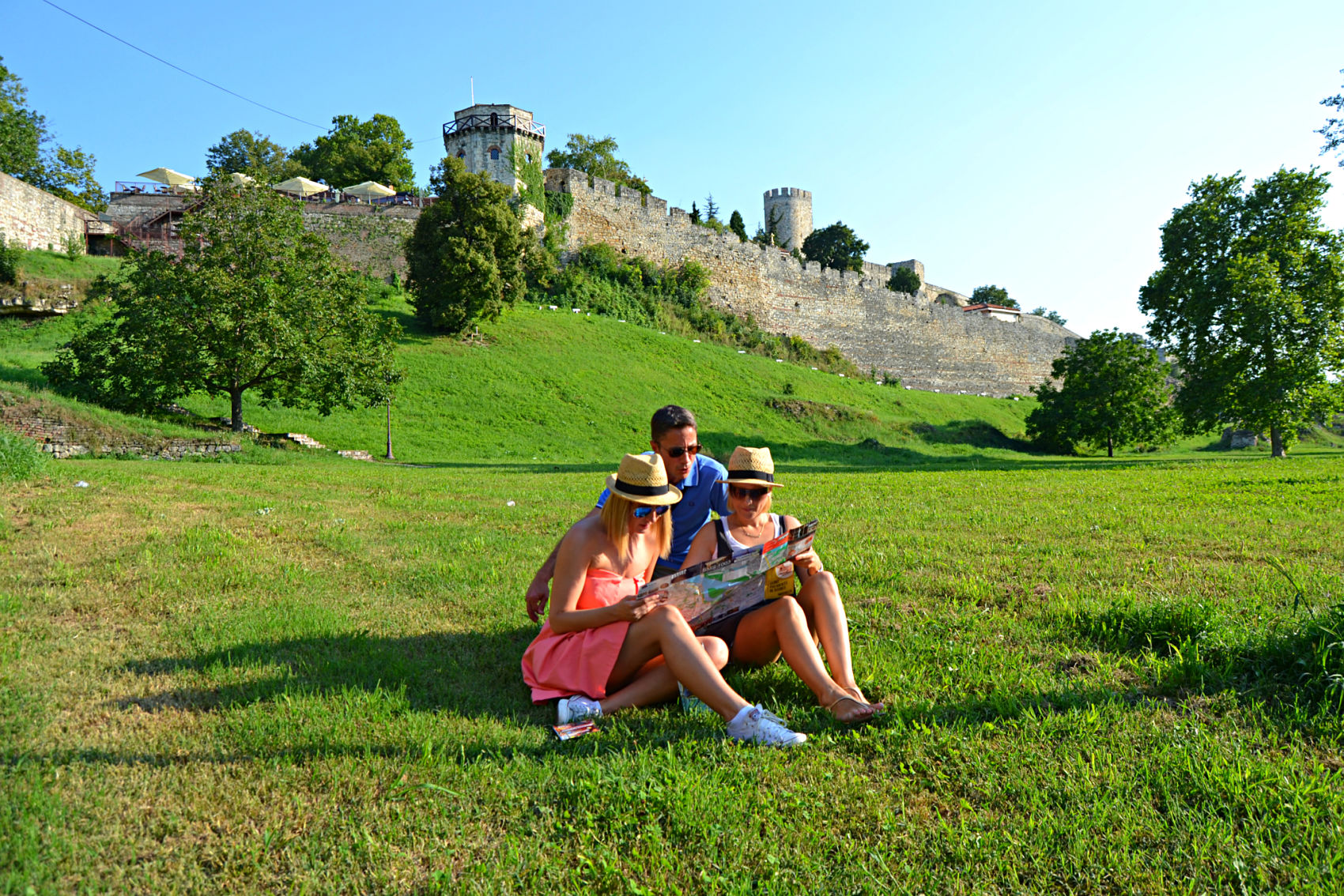 Young people siting the park in fron of Kalemegdan Fortress,Belgrade